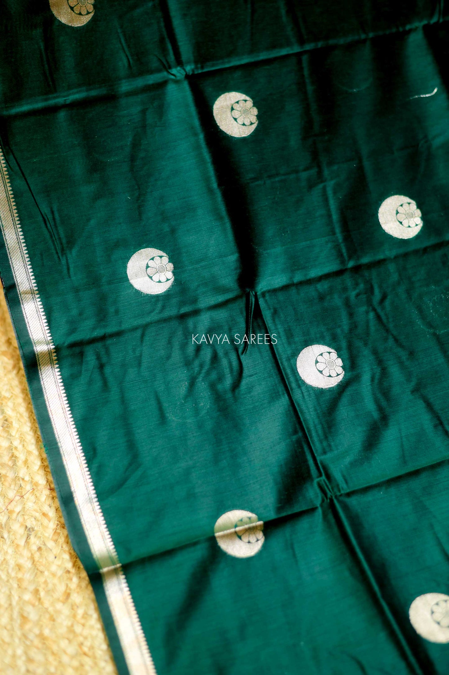 Elegant emerald green Chanderi saree with silver zari motifs and rich festive appeal