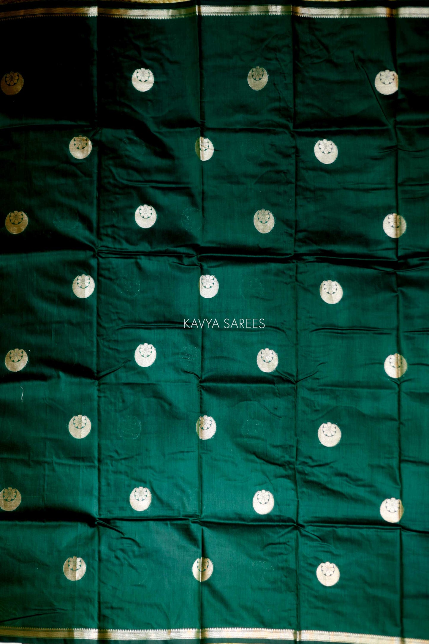Elegant emerald green Chanderi saree with silver zari motifs and rich festive appeal