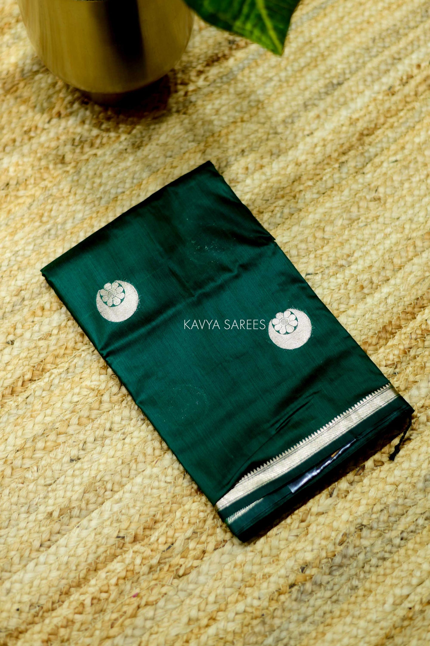 Elegant emerald green Chanderi saree with silver zari motifs and rich festive appeal